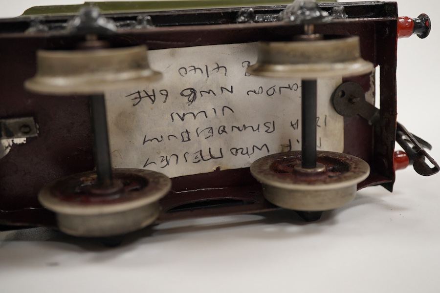 An 0 gauge live steam spirit fired tinplate GWR 4-4-0 tender locomotive, possibly Bing for Bassett-Lowke, 3411, with original fuel tank and burner, two controls in the cab and four wheel tender